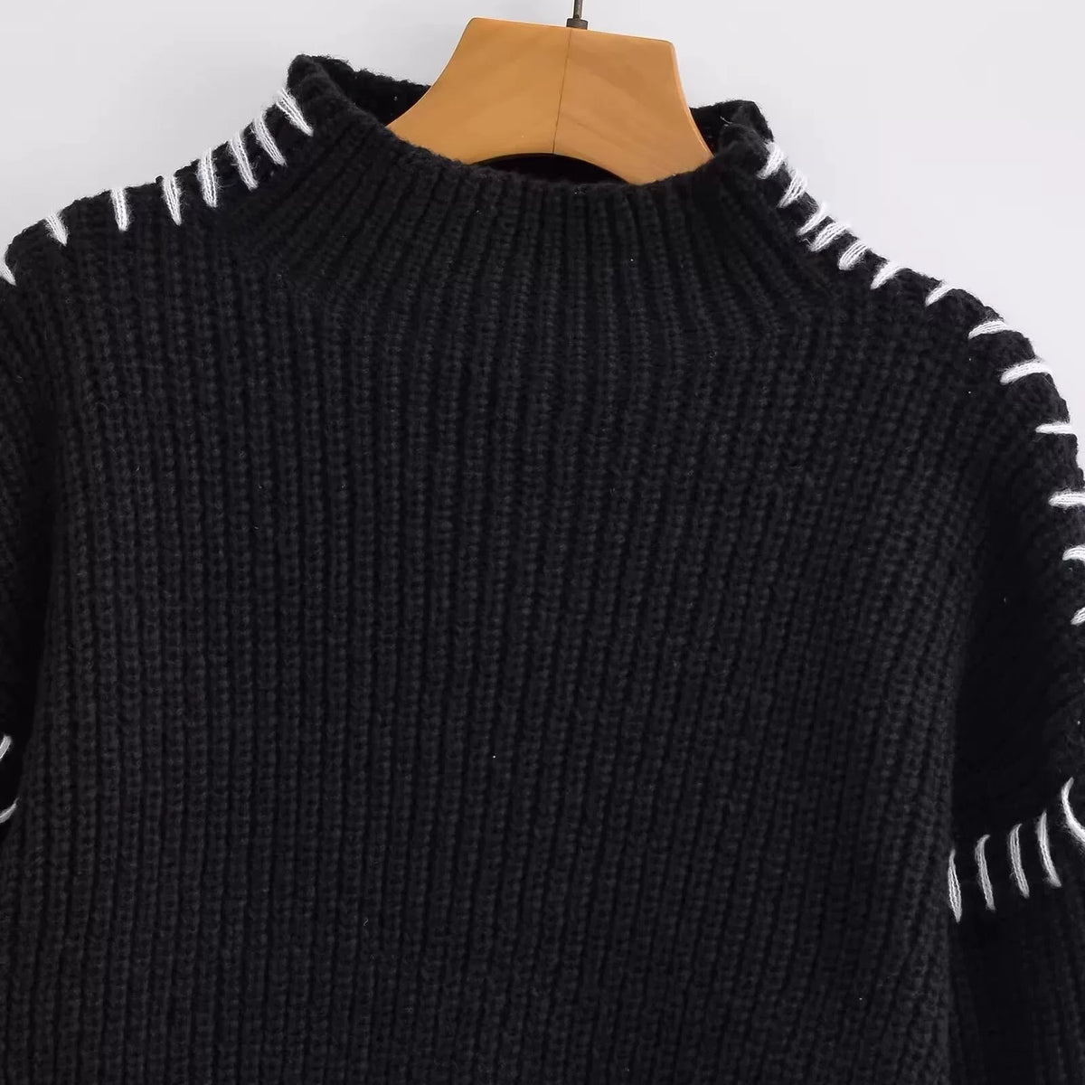 Mock neck and blanket stitching, close-up