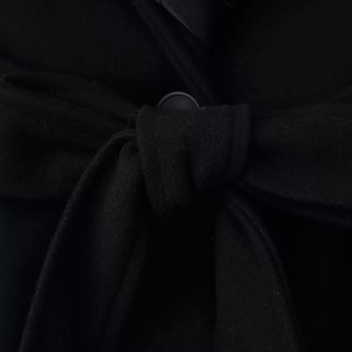 Tie belt and button fastening, close-up