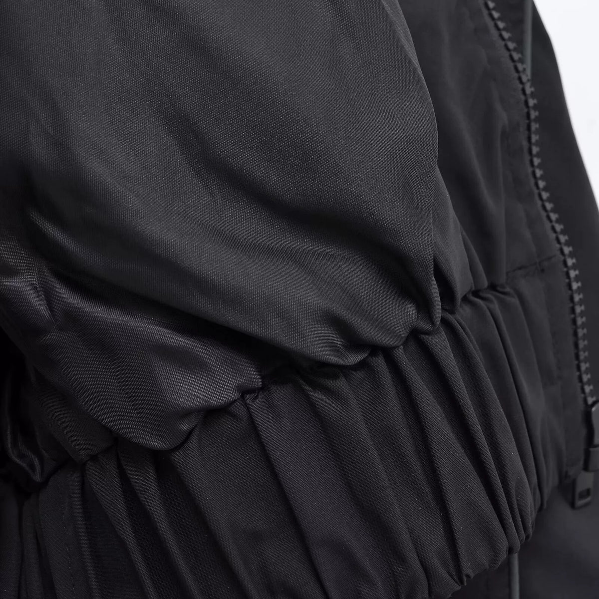 Zip front and gathered elastic hem, close-up