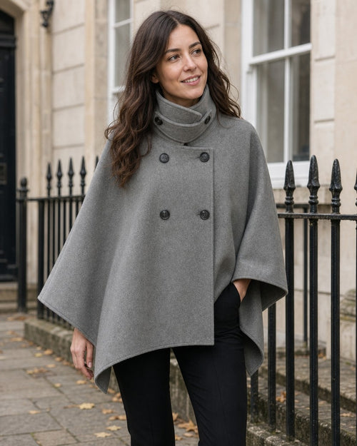 Grey double-breasted cape coat with funnel neck styled on a model (AI-generated image)