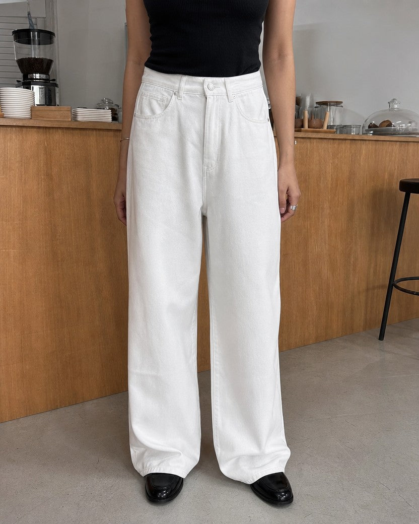 White high-waist wide-leg denim-look trousers styled on a model (AI-generated image)