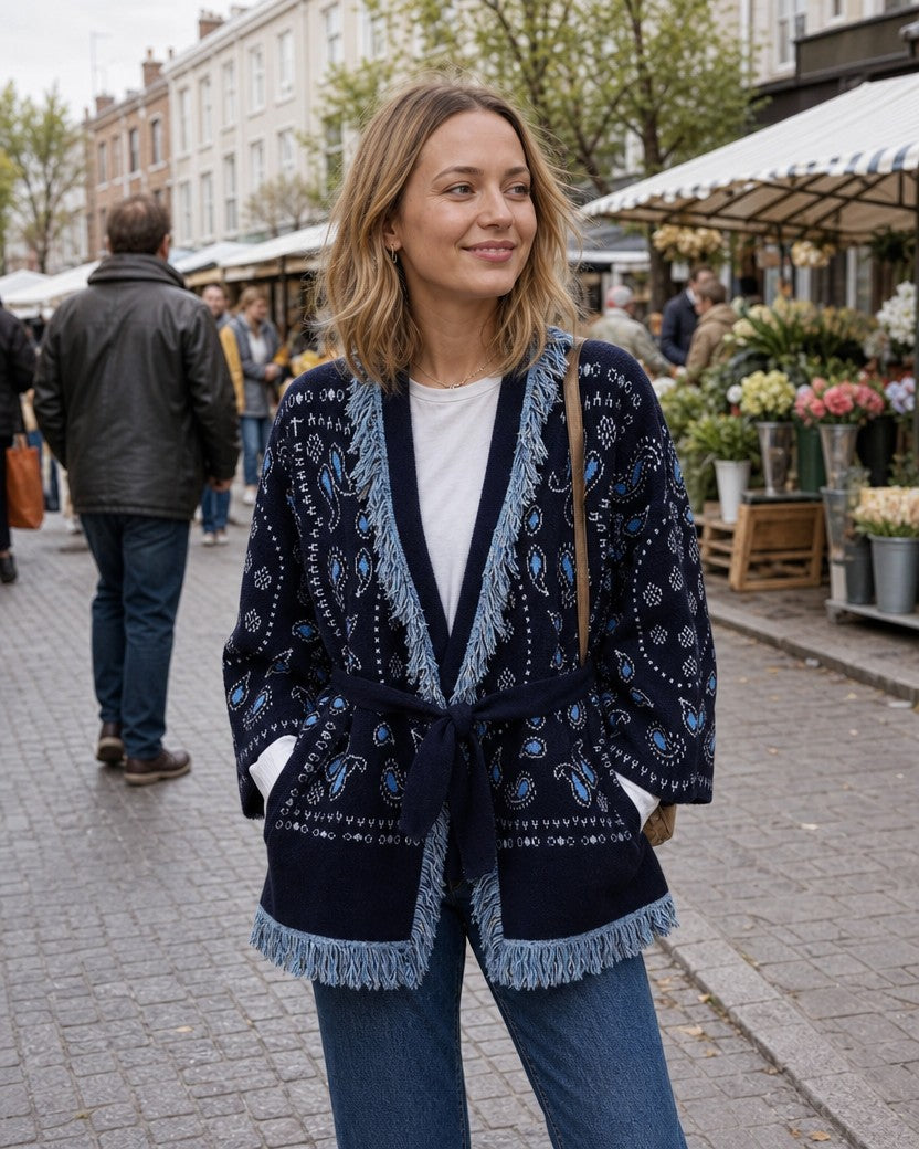 Navy paisley jacquard knit jacket with fringe trim styled on a model (AI-generated image)