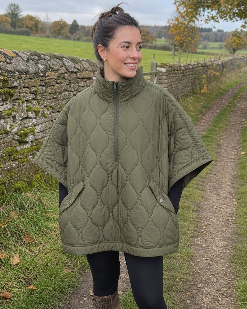 Green quilted puffer cape with half zip styled on a model (AI-generated image)