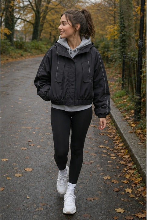 Black hooded cropped windbreaker styled on a model (AI-generated image)